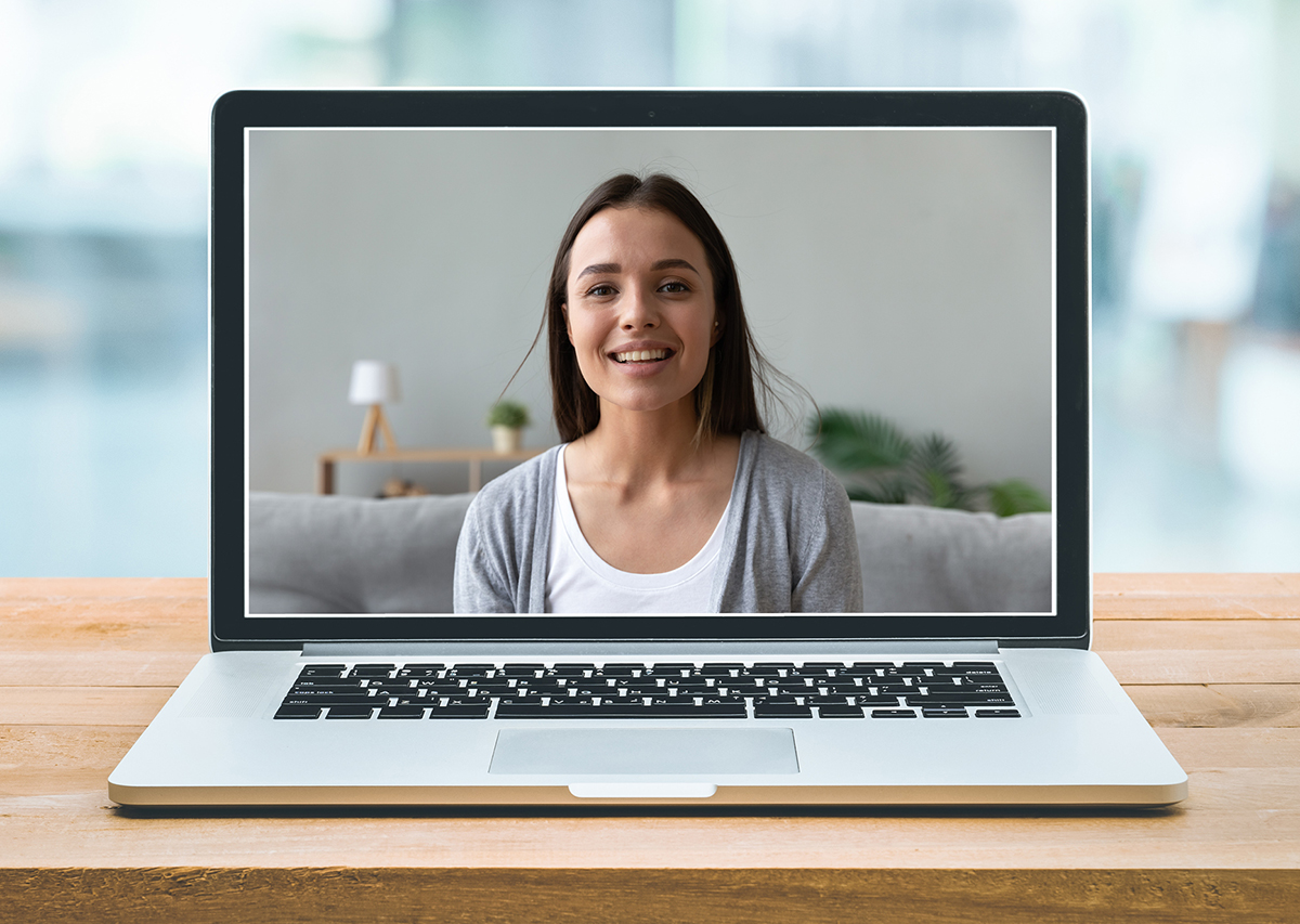 woman smiling on laptop screen